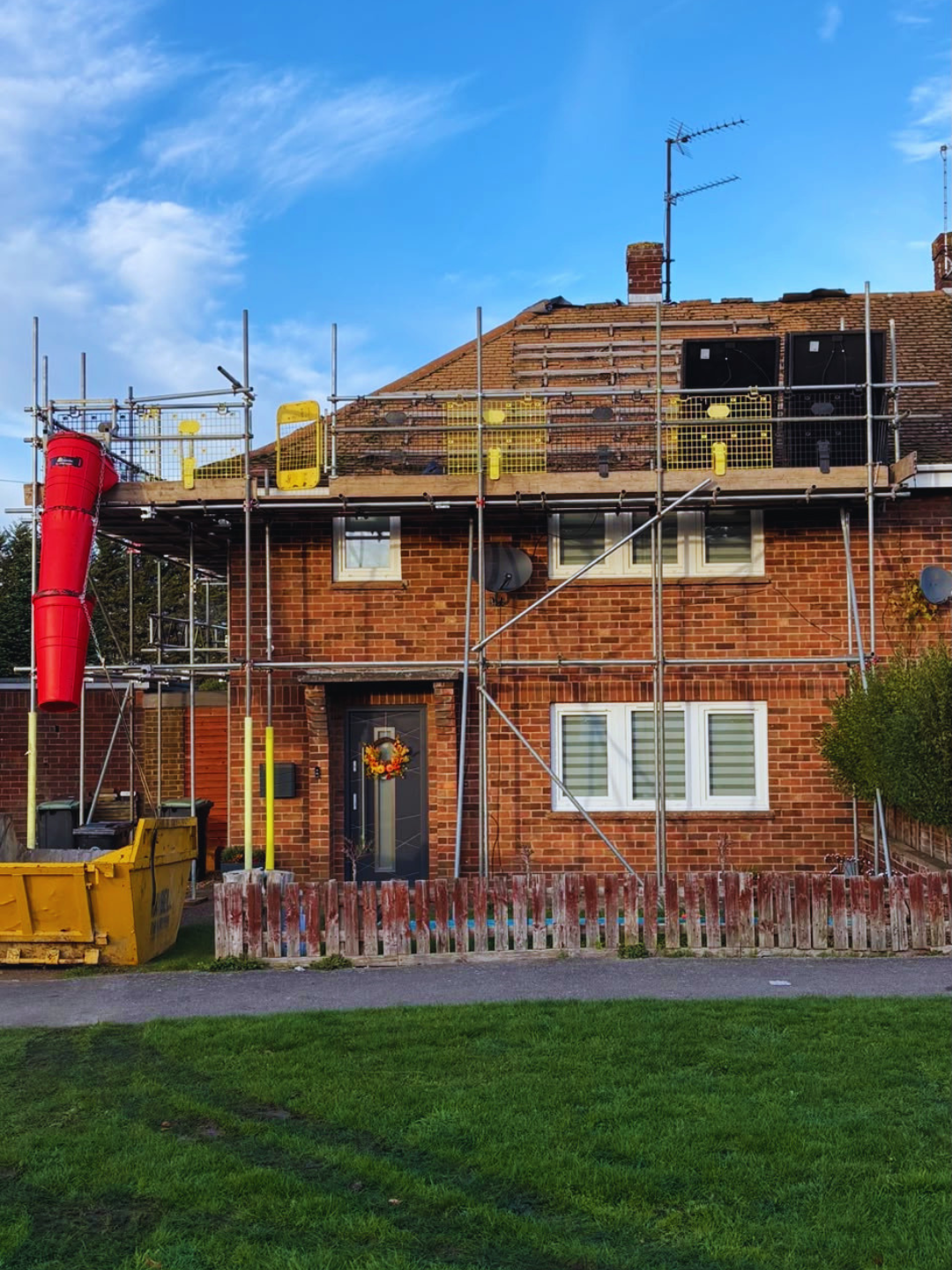 Roof scaffolding to a semi-detached house mid re-roof