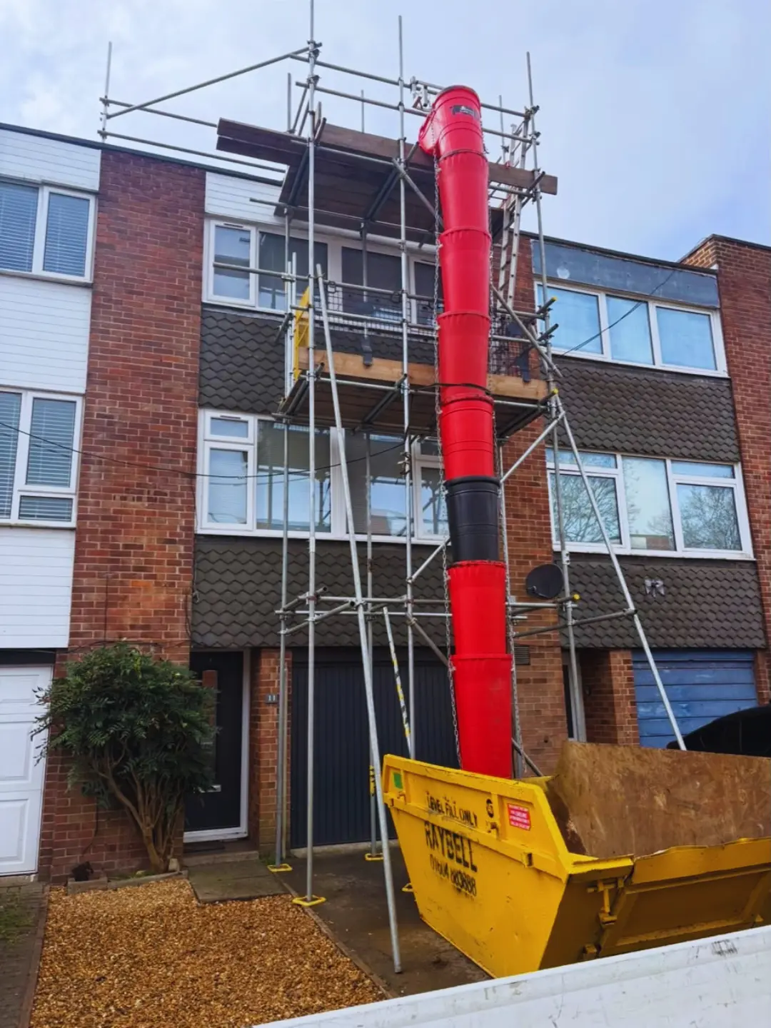 Three storey roof scaffold with debris chute and skip